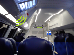 Speaker in a train, with symbolic sound waves emitted
